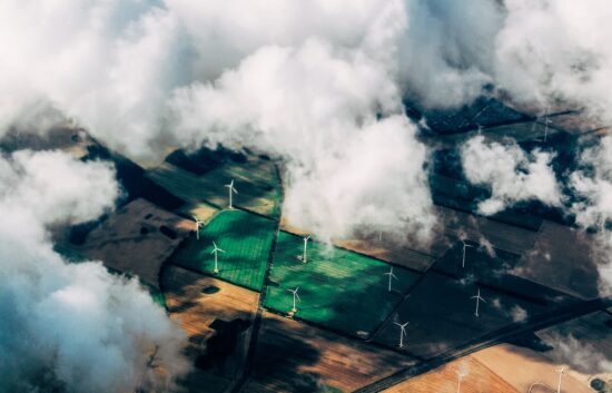 aerial photo of wind turbines near field